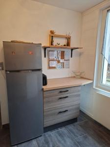 a kitchen with a refrigerator and a counter at La Bourboule in La Bourboule