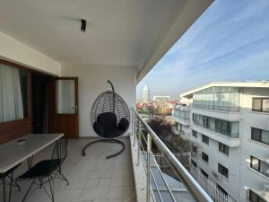 a balcony with a chair and a view of a city at OTTO X Hotel in Kavaklıdere