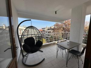 a room with a swing on a balcony with a table at OTTO X Hotel in Kavaklıdere