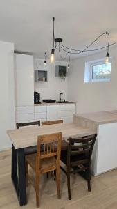 a kitchen and dining room with a table and chairs at The Garden Residence in Falkenburg +20 photos