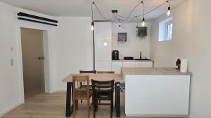 a kitchen and dining room with a table and chairs at The Garden Residence in Falkenburg