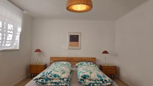 a bedroom with two beds and two night stands at The Garden Residence in Falkenburg