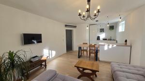 a living room with a couch and a table at The Garden Residence in Falkenburg