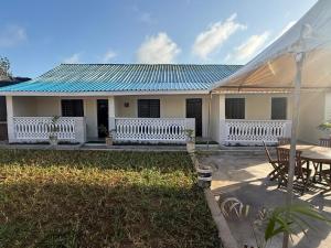 a house with a table and a patio at Malaika Gardens resort in Diani Beach