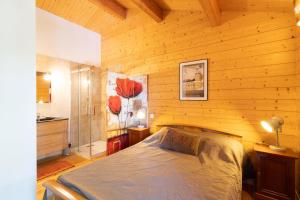 a bedroom with a bed in a wooden room at Chalet Edliane in Font-Romeu-Odeillo-Via