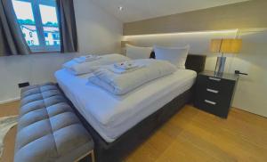 a bedroom with a large bed with towels on it at Ferienwohnung "Krainsbergkogel" - Edles Dachgeschossapartment mit Bergblick in Schliersee