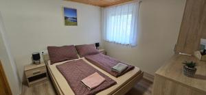 a small bedroom with a bed with purple sheets and a window at Anna-Lak in Dunapataj +46 photos