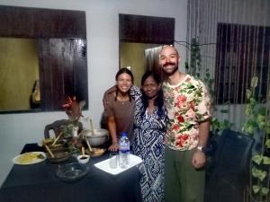 a group of three people standing next to a table at Venus Inn Goyambokka in Tangalle
