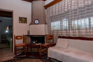 a living room with a bed and a fireplace at Andreas House in Valíra