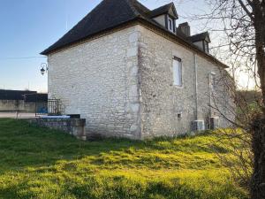 an old brick building with a roof on a field at Rocamadour in Rocamadour
