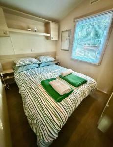 a bedroom with a bed with green sheets and a window at St Tropez Surprise in Gassin +27 photos