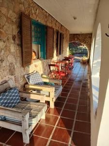 a patio with chairs and tables in a building at Casa Dos Arcos Bed and Breakfast in Arraial do Cabo +7 photos