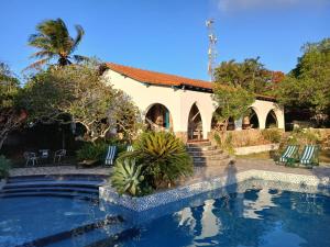 a house with a swimming pool and a building at Casa Dos Arcos Bed and Breakfast in Arraial do Cabo