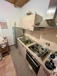 a kitchen with a stove and a sink at Beautiful apartment surrounded by greenery in Chiaramonti