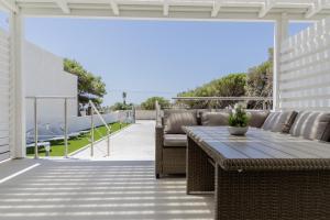 a patio with a table and chairs on a patio at Holiday burrone in Favignana