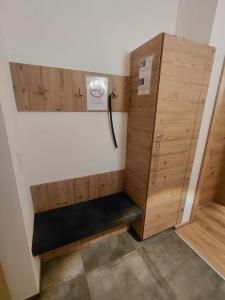 a locker room with a bench in the corner at Apart Monte Vista in Längenfeld +4 photos