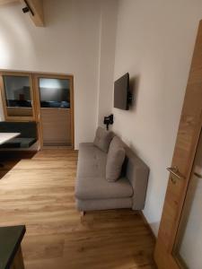 a living room with a couch and a flat screen tv at Apart Monte Vista in Längenfeld