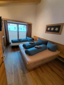 a living room with blue pillows and a couch at Apart Monte Vista in Längenfeld