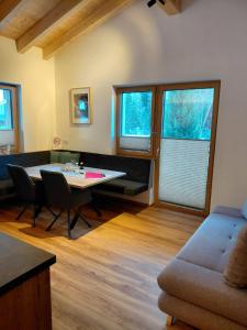 a living room with a table and a couch at Apart Monte Vista in Längenfeld