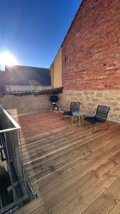 two chairs and a table on a wooden deck at Ferienwohnung Anja in Münnerstadt