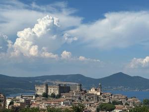 a city with buildings and a cloudy sky at Marianna Guest House in Bracciano