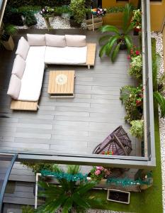 an overhead view of a patio with furniture and plants at Galliera Residence B&B in Bologna