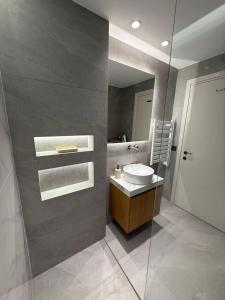 a bathroom with a sink and a mirror at Sea View Nafplio Luxury Apartment in Nafplio +33 photos