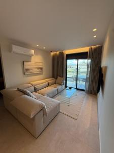 a large living room with a couch and a television at Sea View Nafplio Luxury Apartment in Nafplio