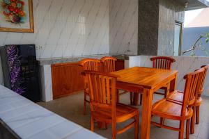 a kitchen with a wooden table and chairs at Sundara Haven in Ungasan +17 photos