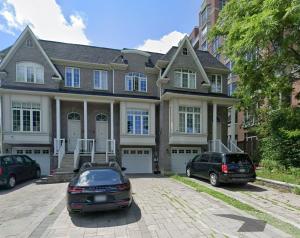 a house with two cars parked in front of it at Quiet Private Master Suite w Ensuite Great Value in Bélanger