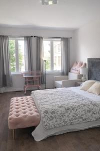 a bedroom with a large bed and a couch at Quiet Private Master Suite w Ensuite Great Value in Bélanger