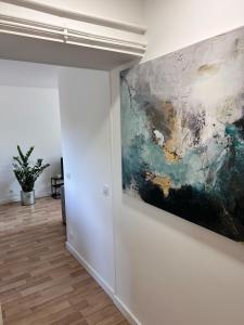 a painting hanging on a wall in a room at L'escapade in Pont-de-Veyle