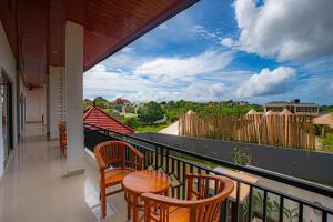 a balcony with a table and chairs and a view at Sundara Haven in Ungasan