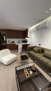 a living room with a couch and a table at Wadi Hanifa View وادي حنيفة ڤيو in Riyadh