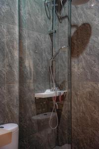 a bathroom with a shower and a toilet at Sundara Haven in Ungasan