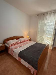 a bedroom with a large bed and a window at Coastal dream in Razvala