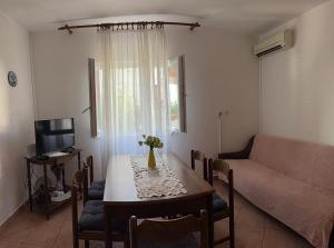 a living room with a table and a couch at Coastal dream in Razvala