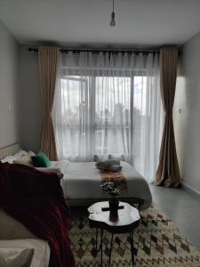 a bedroom with two beds and a window at Solara Loft in Nairobi +7 photos