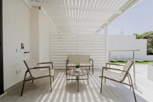 two chairs and a table on a patio at Holiday burrone in Favignana