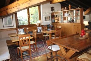 a dining room with wooden tables and chairs at Hotel Dente Del Gigante in Courmayeur
