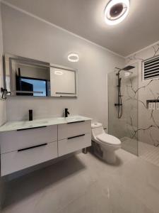 a bathroom with a sink and a toilet and a shower at Isabela Luxury Escape sky view in Isabela +11 photos