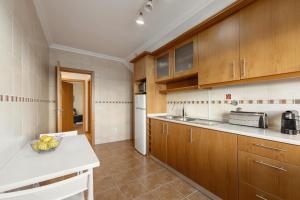 a kitchen with wooden cabinets and a bowl of fruit on a counter at Ferrel Dreams in Ferrel