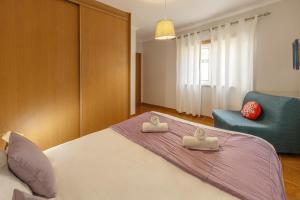 a bedroom with a bed and a blue chair at Ferrel Dreams in Ferrel