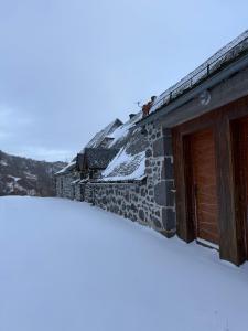 a house with snow on the roof at Le Domaine Belinay in Paulhac