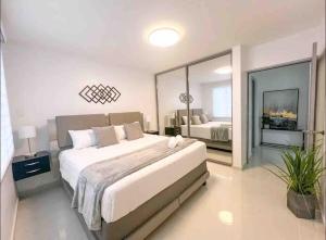 a bedroom with a large bed and a large mirror at Isabela Luxury Escape Serenity in Isabela