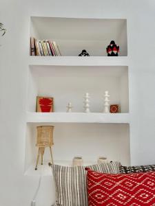 a living room with white shelves and a couch at Dar Raphael in Essaouira