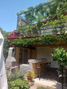 a house with a patio with chairs and a stove at Vila Georgeta, Camere de închiriat in Techirghiol +6 photos
