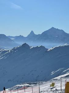 a person is skiing on a snow covered mountain at Chalet Abendruh Belalp in Naters