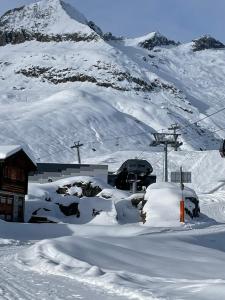 a snow covered mountain with a ski lift at Chalet Abendruh Belalp in Naters +25 photos
