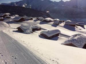 a snow covered village with a mountain in the background at Chalet Abendruh Belalp in Naters